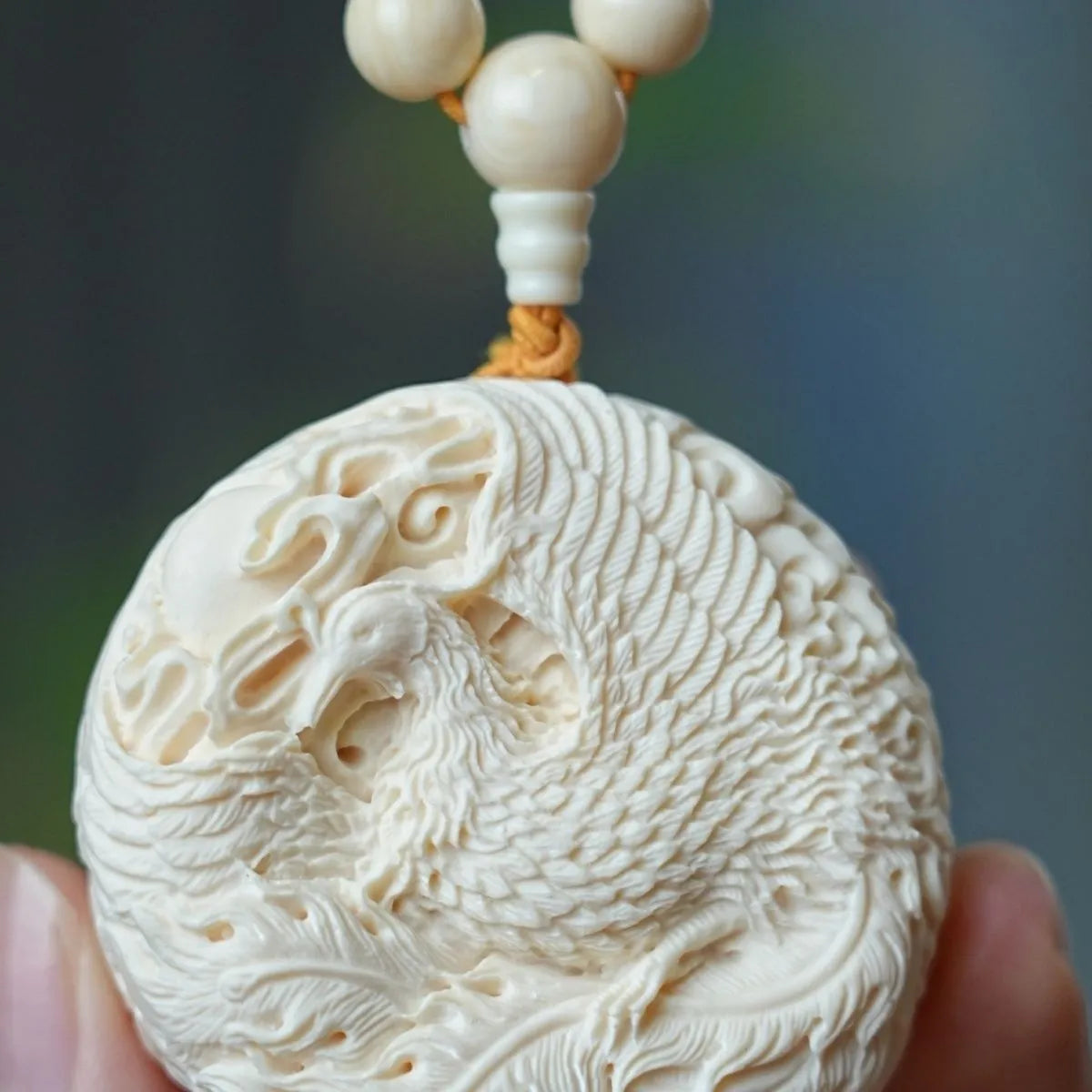 Hand - carved Double - sided Mammoth Ivory Pendant with Dragon and Phoenix Patterns. It can be used as a hanging ornament, a necklace pendant, a Buddhist bead pendant, or a trendy sweater chain.