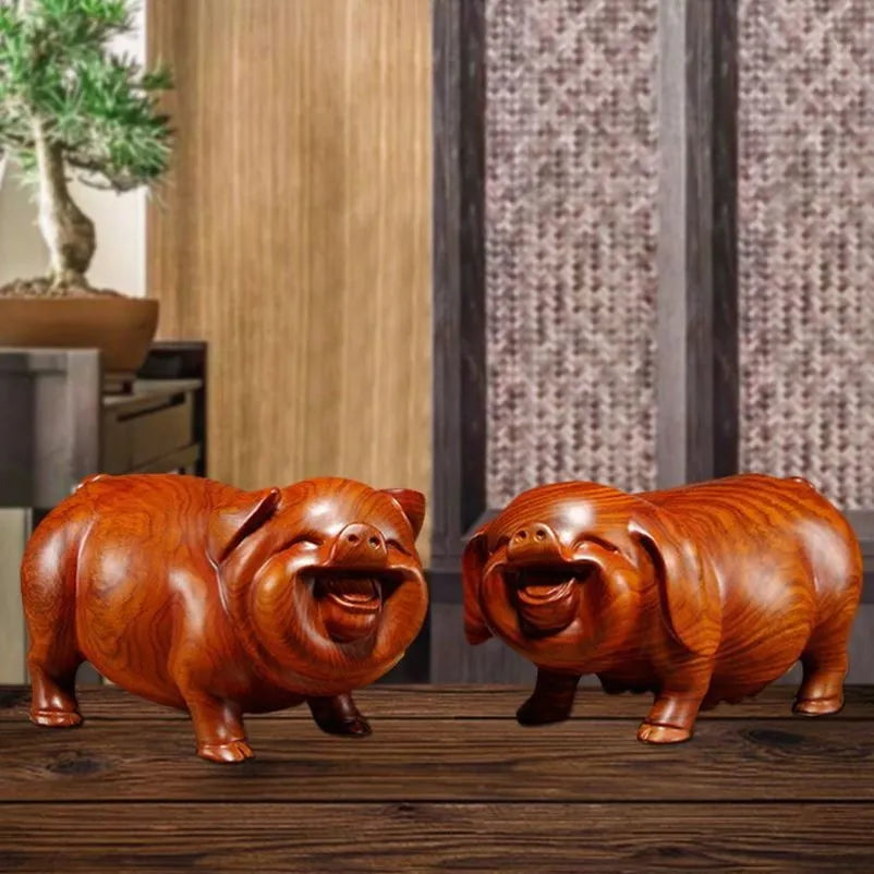 Pear wood carving of the pig, redwood and ebony wood carvings of the pig among the twelve Chinese zodiac animals for attracting wealth. They are tabletop birthday gifts, the lucky golden pig ornaments.
